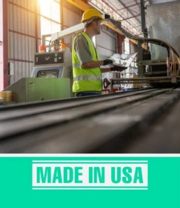 Worker in safety gear operates machinery in a factory. Text reads "Made in USA." Production of home elevators possible.